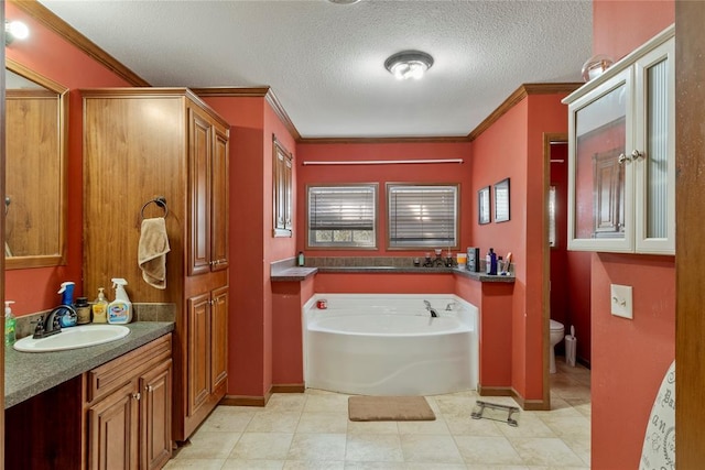 full bathroom featuring toilet, a textured ceiling, a garden tub, and ornamental molding