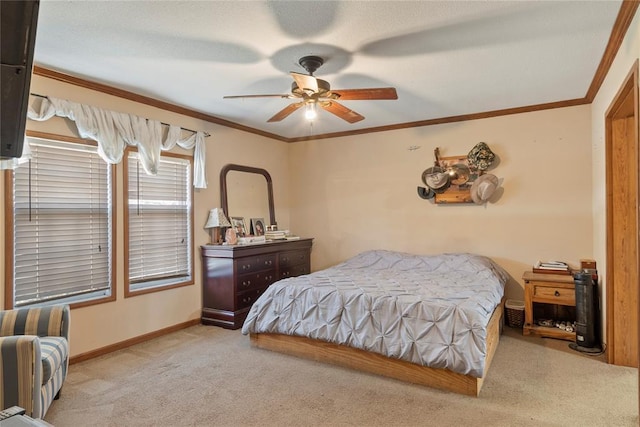 bedroom with carpet flooring, a ceiling fan, crown molding, and baseboards