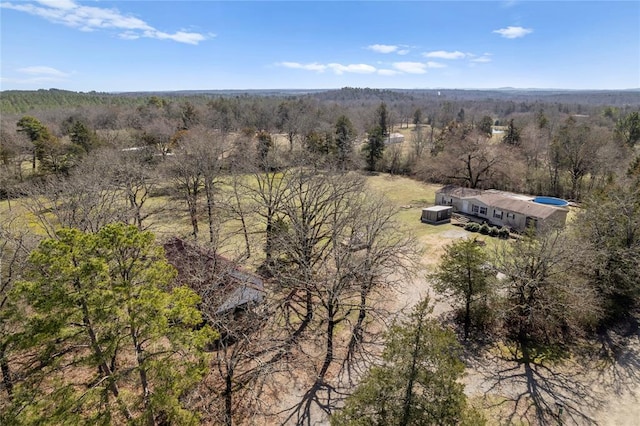 birds eye view of property with a view of trees