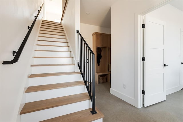 stairway with carpet flooring and baseboards