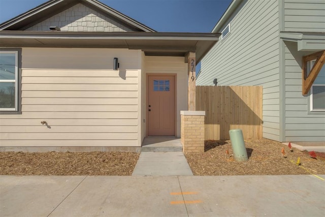 doorway to property with fence