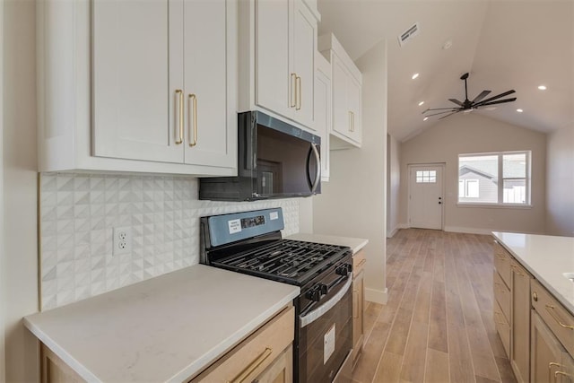 kitchen featuring visible vents, stainless steel appliances, light countertops, light wood-style floors, and backsplash