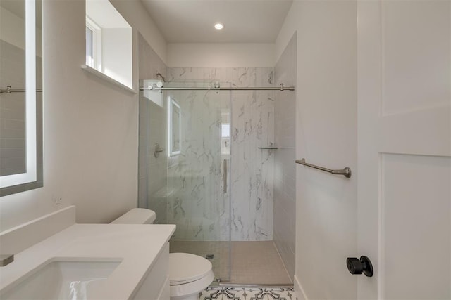 full bath featuring a marble finish shower, toilet, and vanity