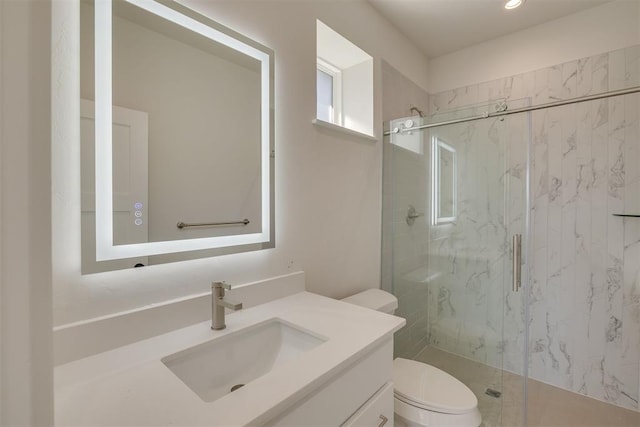 bathroom with a marble finish shower, toilet, and vanity