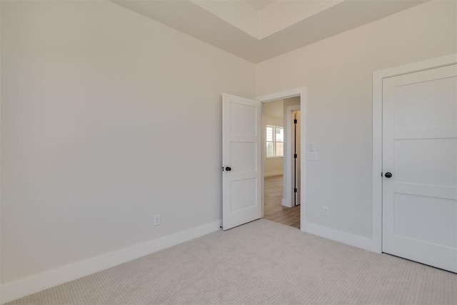 unfurnished bedroom with carpet flooring and baseboards