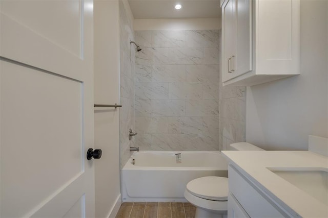 bathroom with toilet, vanity, shower / bath combination, and wood finished floors