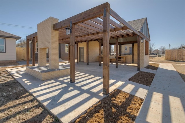 view of patio with a pergola and fence