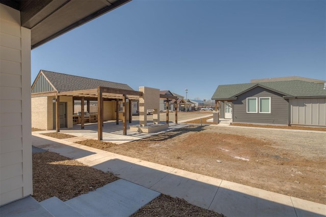 view of yard with a residential view, a patio, and a pergola