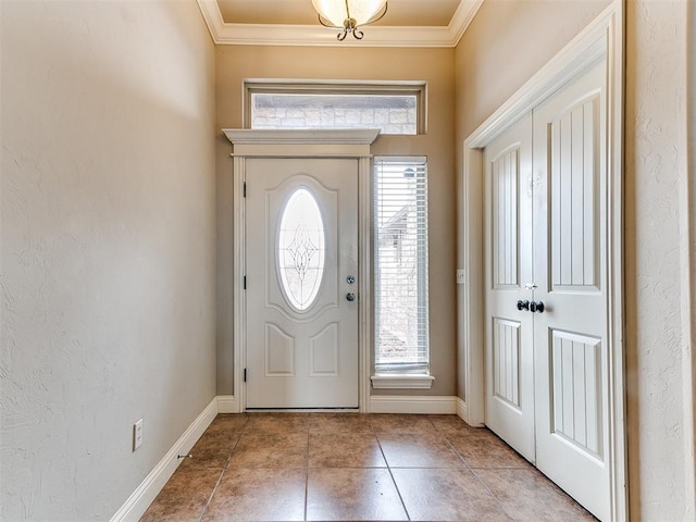 entryway with crown molding, light tile patterned flooring, a textured wall, and baseboards