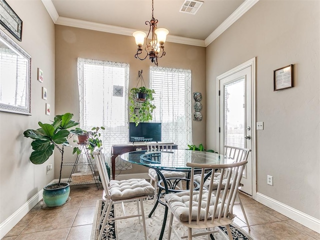 dining area featuring crown molding, baseboards, visible vents, and a chandelier