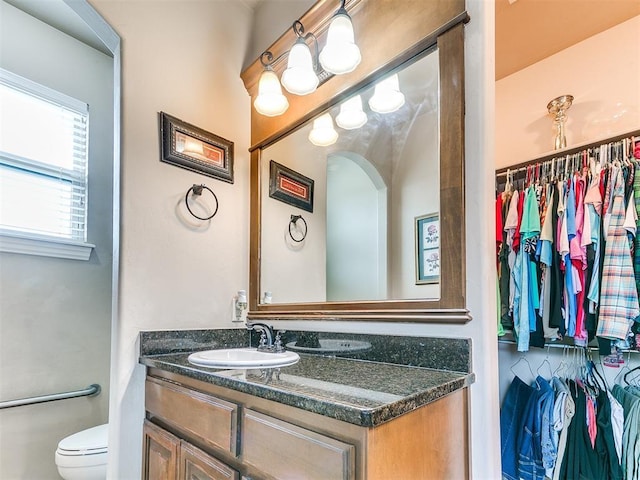 bathroom featuring toilet and vanity