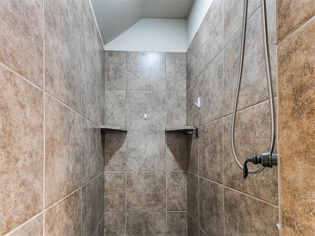 interior details with a tile shower