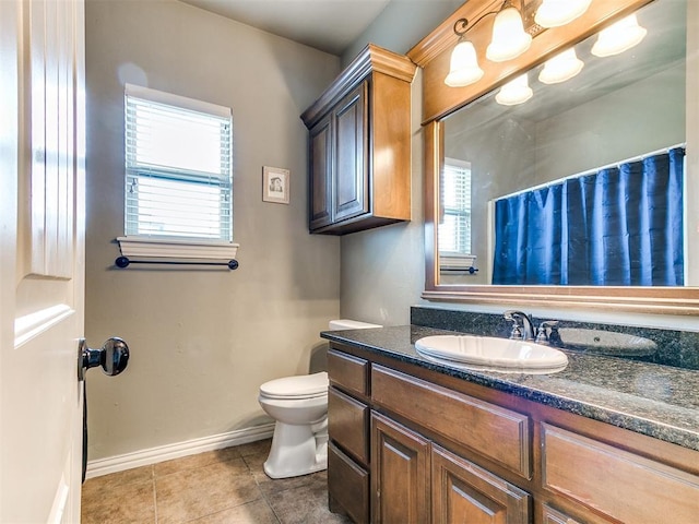 bathroom featuring baseboards, toilet, a shower with curtain, tile patterned floors, and vanity