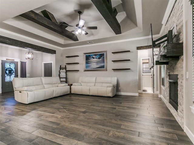 living area with a ceiling fan, dark wood-style flooring, and a fireplace