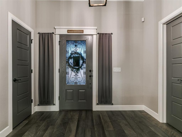 entryway with dark wood finished floors and baseboards