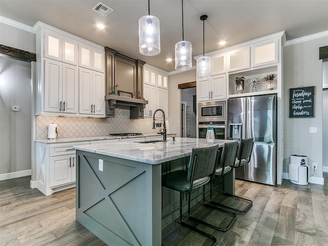 kitchen with visible vents, open shelves, a sink, appliances with stainless steel finishes, and light stone countertops