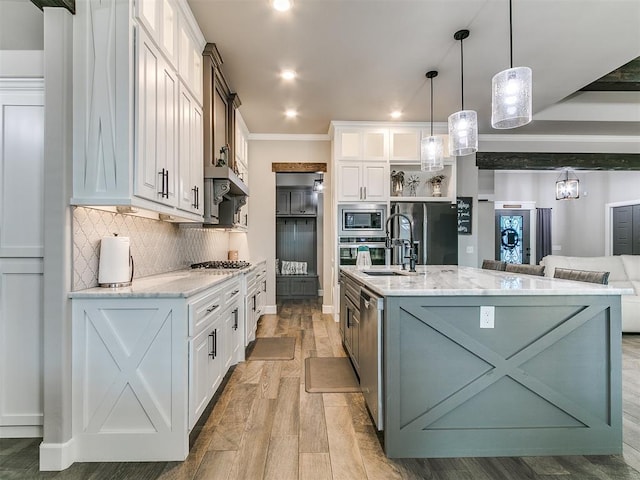 kitchen featuring decorative backsplash, appliances with stainless steel finishes, white cabinetry, and light stone countertops