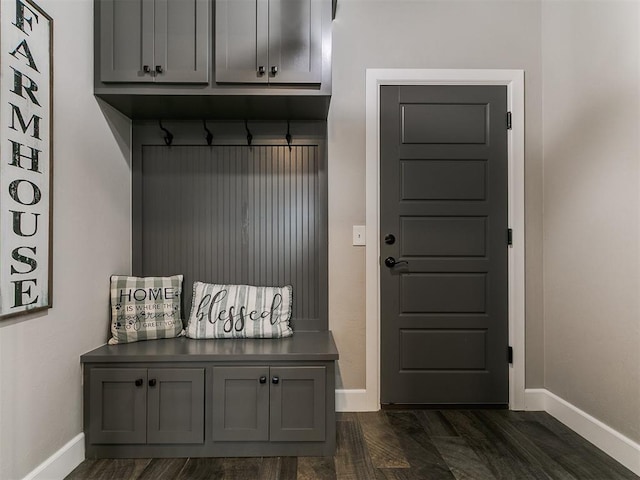 mudroom featuring baseboards and dark wood-type flooring