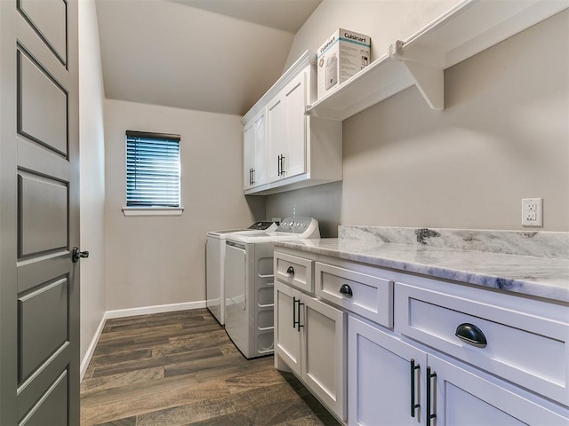 clothes washing area featuring washer and dryer, cabinet space, dark wood finished floors, and baseboards