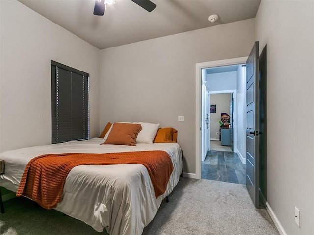 carpeted bedroom featuring baseboards and ceiling fan