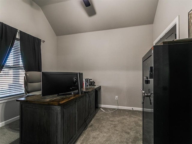 home office with baseboards, lofted ceiling, ceiling fan, and dark carpet