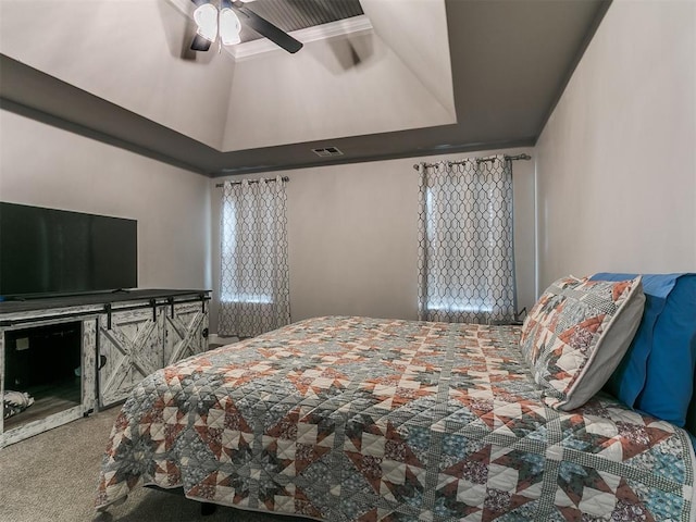 bedroom with visible vents, carpet floors, a raised ceiling, and ceiling fan