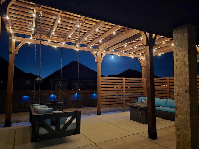 patio at night featuring an outdoor living space and a pergola