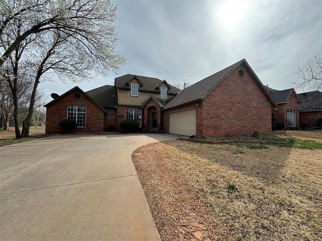 traditional-style home featuring brick siding, roof with shingles, concrete driveway, and an attached garage