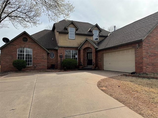 view of front of home featuring brick siding, an attached garage, concrete driveway, and roof with shingles