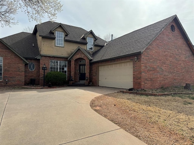 view of front of home featuring brick siding, an attached garage, driveway, and roof with shingles