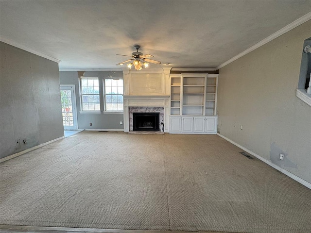 unfurnished living room with light carpet, visible vents, ceiling fan, and ornamental molding