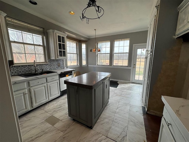 kitchen featuring a sink, marble finish floor, crown molding, and dishwasher