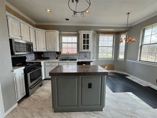 kitchen with a sink, marble finish floor, appliances with stainless steel finishes, crown molding, and tasteful backsplash