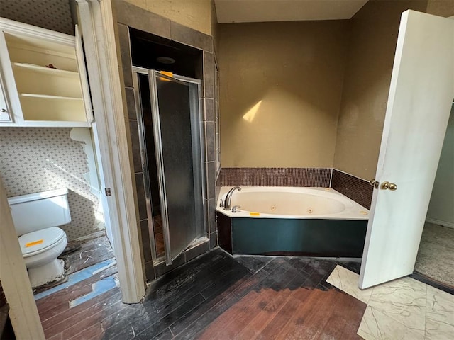 bathroom featuring wood finished floors, a shower stall, toilet, and a whirlpool tub