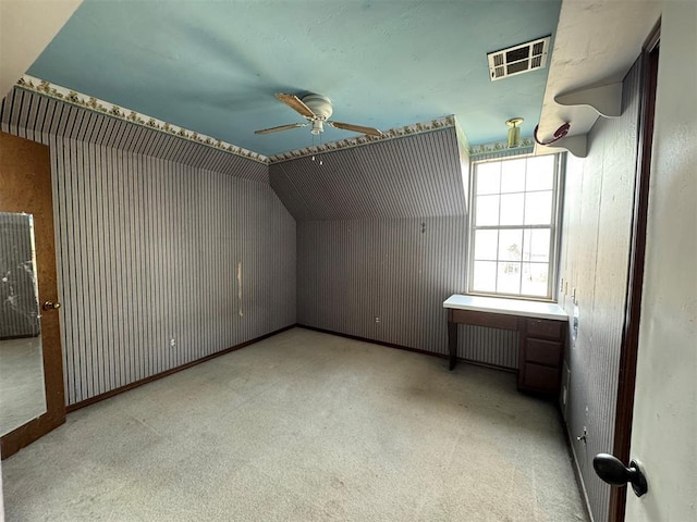 additional living space with visible vents, carpet flooring, ceiling fan, and radiator heating unit