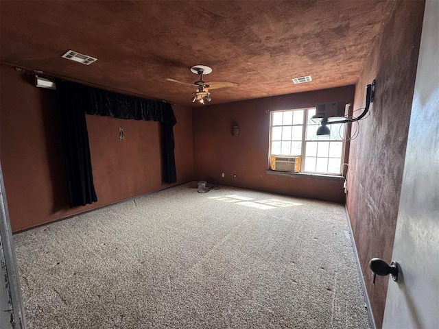 carpeted empty room featuring visible vents, cooling unit, and ceiling fan