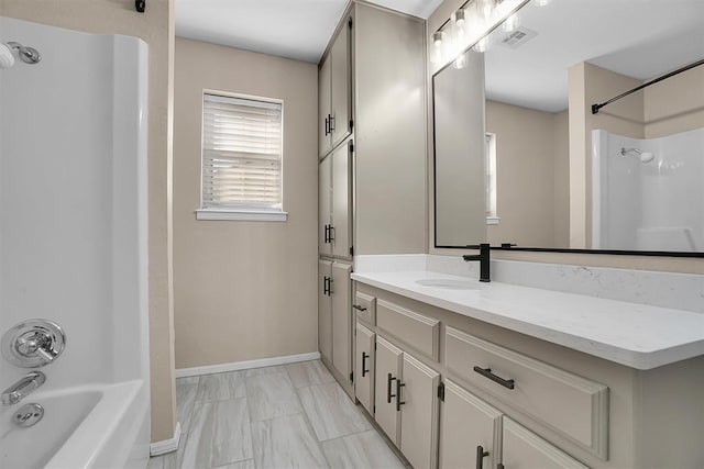 703 Comanche Trl, Altus, OK 73521 - full bathroom featuring marble look tiles, vanity, and washtub / shower combination