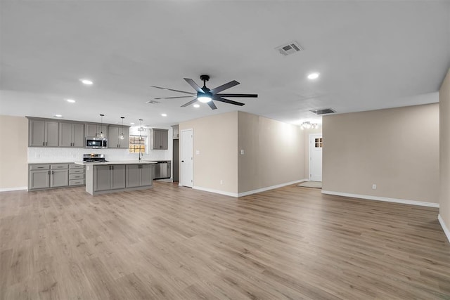 703 Comanche Trl, Altus, OK 73521 - unfurnished living room featuring recessed lighting, light wood-style floors, and a ceiling fan
