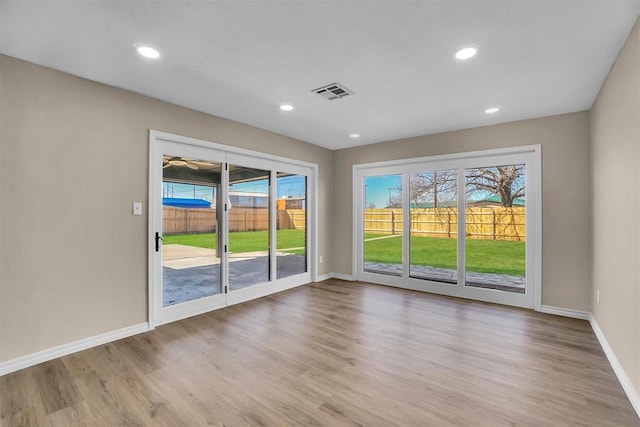 703 Comanche Trl, Altus, OK 73521 - empty room with wood finished floors and recessed lighting