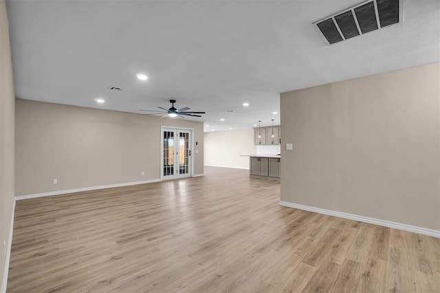703 Comanche Trl, Altus, OK 73521 - unfurnished living room with recessed lighting, light wood finished floors, ceiling fan, and french doors