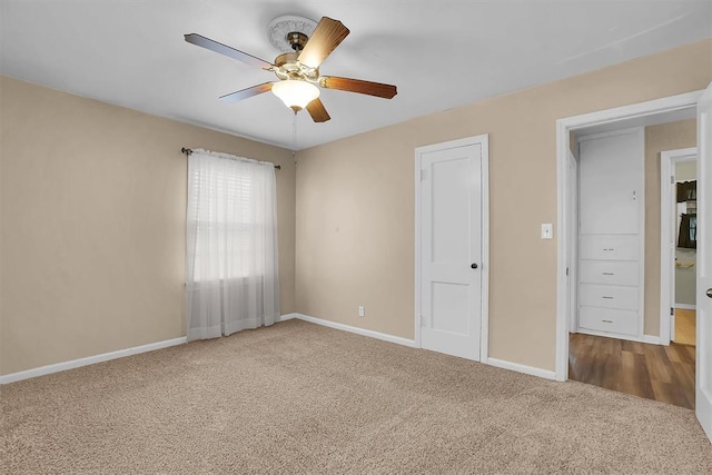 unfurnished bedroom with baseboards, carpet, and a ceiling fan