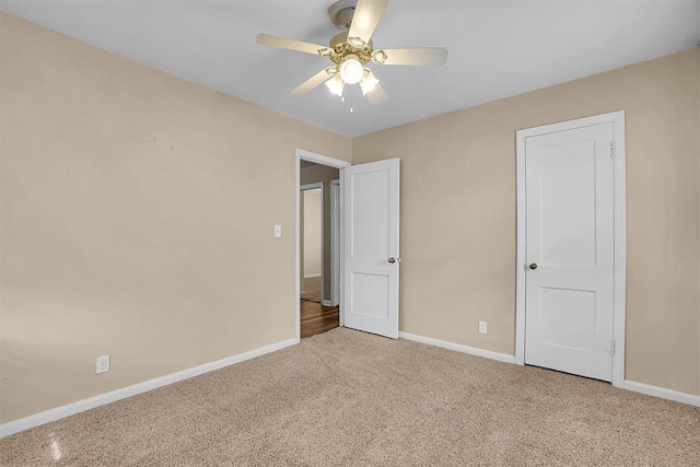 unfurnished bedroom featuring baseboards, carpet, and ceiling fan