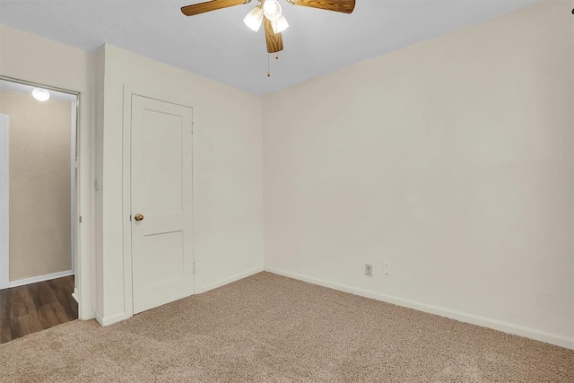 empty room featuring carpet flooring, baseboards, and ceiling fan