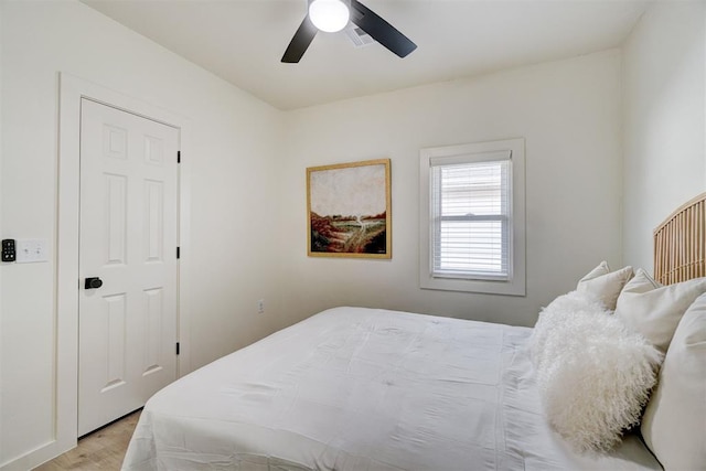 bedroom with visible vents, a ceiling fan, and light wood finished floors