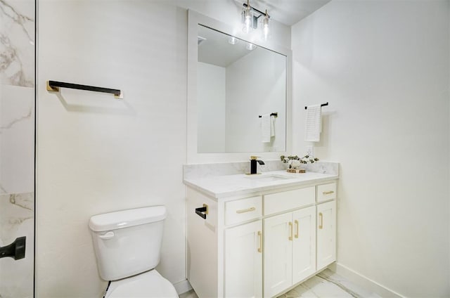 bathroom featuring marble finish floor, toilet, vanity, and baseboards