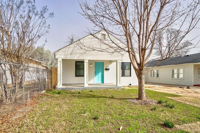 bungalow with a porch, a front yard, and fence