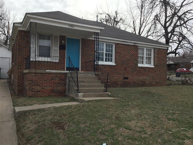 bungalow featuring a front lawn, fence, and brick siding