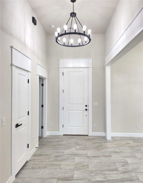 11613 NW 103rd St, Yukon, OK 73099 - foyer with a chandelier and baseboards