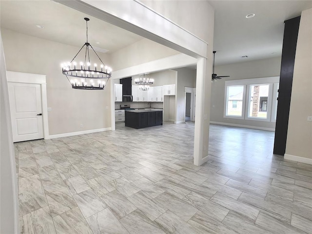 11613 NW 103rd St, Yukon, OK 73099 - unfurnished living room featuring a chandelier, baseboards, and a ceiling fan
