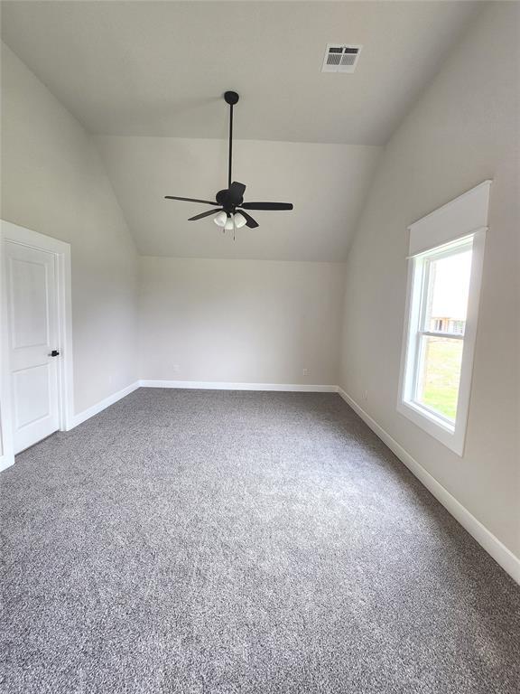 11613 NW 103rd St, Yukon, OK 73099 - bonus room featuring lofted ceiling, a ceiling fan, carpet floors, and baseboards